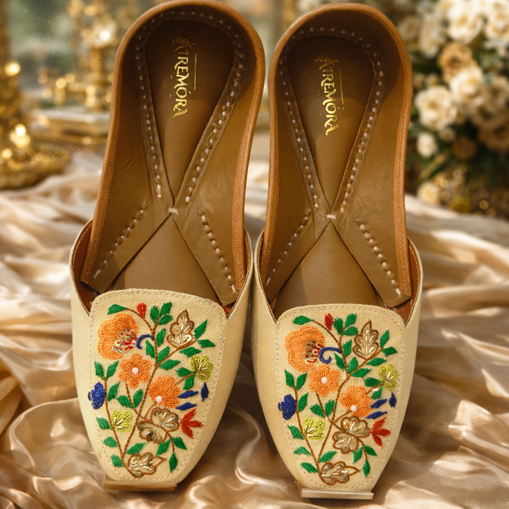 Pair of embroidered shoes with floral patterns on a decorative background