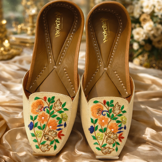 Pair of embroidered shoes with floral patterns on a decorative background